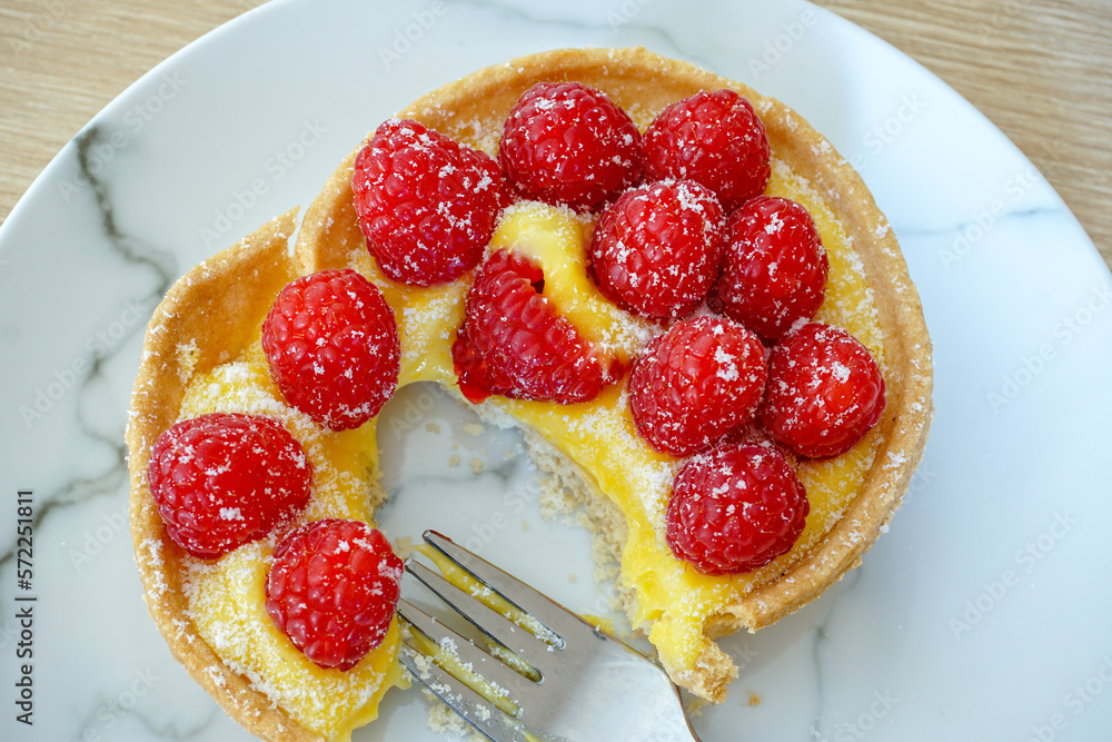 delicious fruit tart. sweet pastry dessert topped with lemon cream and fresh raspberries. A sweet treat delicious fruit tart. sweet pastry dessert topped with lemon cream and fresh raspberries. A sweet treat