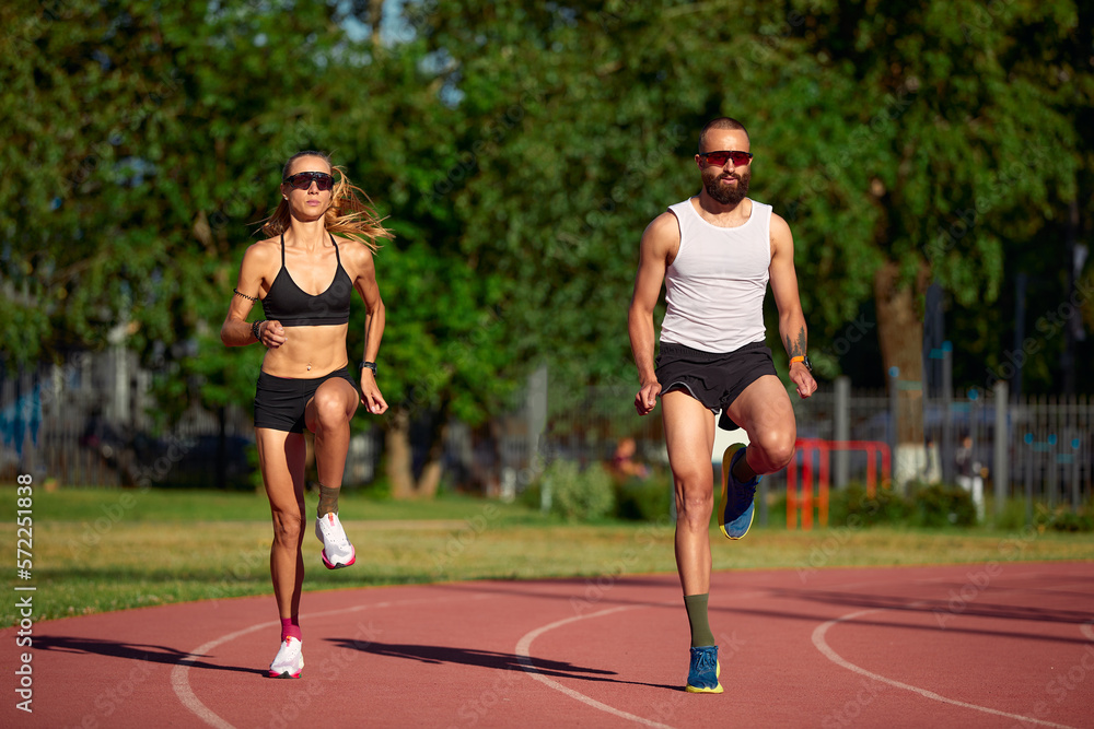 Obraz premium Diversity training man and woman at the stadium, athletics running