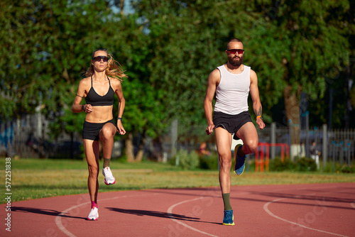 Diversity training man and woman at the stadium, athletics running