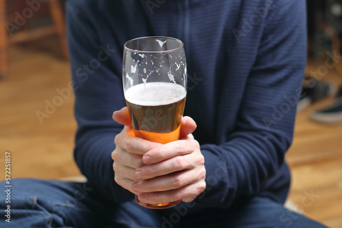 a person holds a mug with beer in his hands