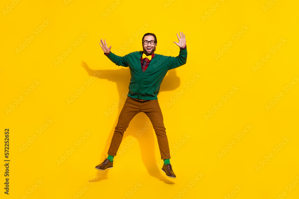 Full body portrait of active overjoyed person jumping have good mood isolated on yellow color background