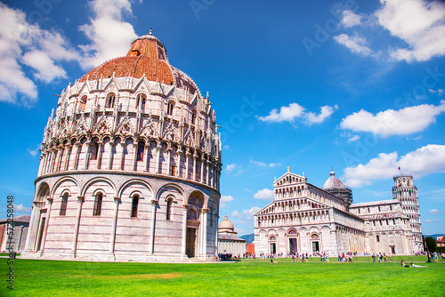 Murais de parede Picturesque landscape with San Giovanni Baptistery, part of cathedral or Duomo di Santa Maria Assunta near famous Leaning Tower in Pisa, Italy