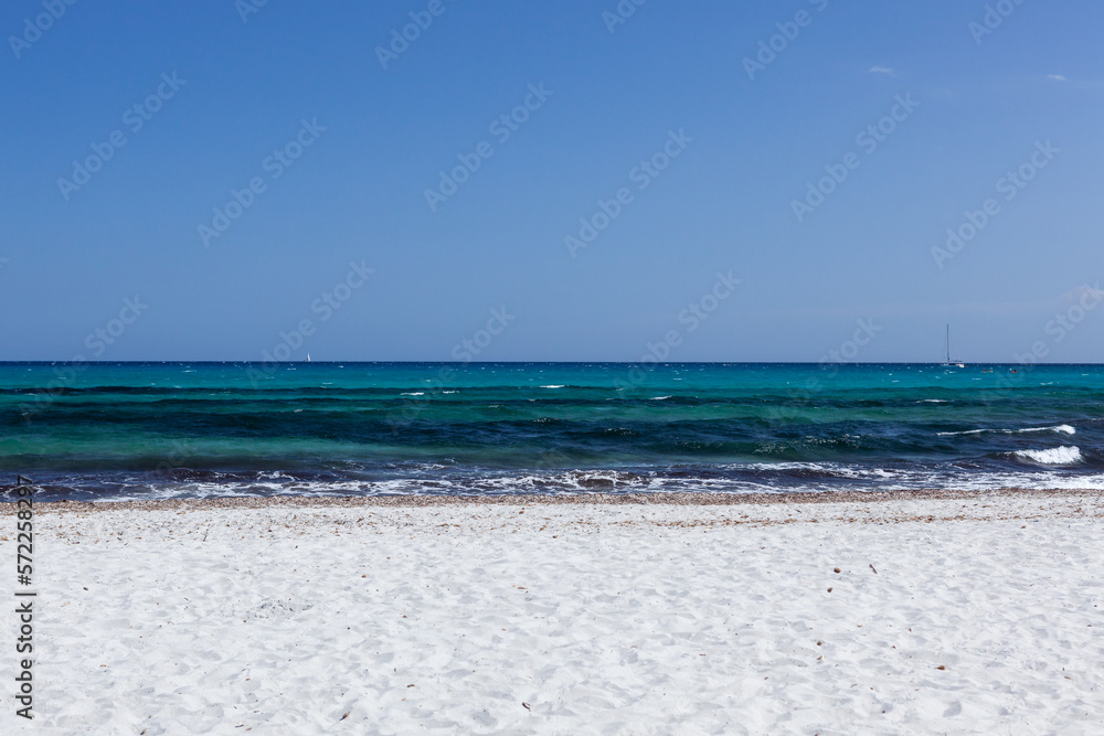 White sand beach and clear blue water of Mediterranean sea. Sardinia, Italy on sunny day.