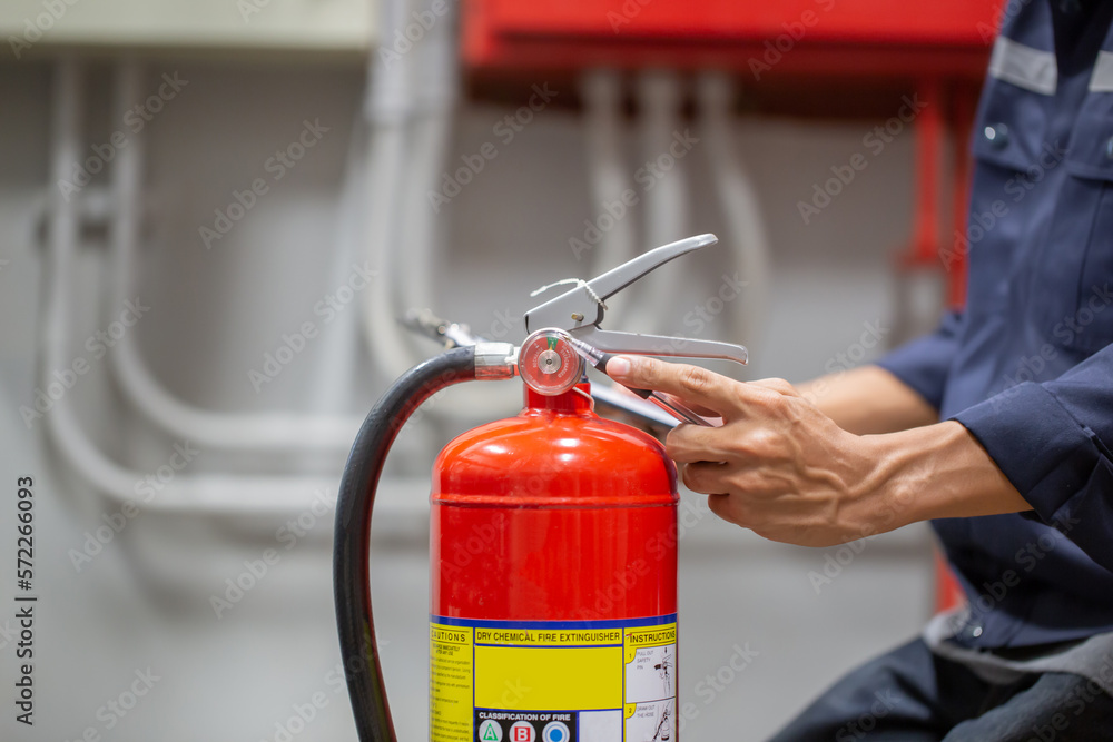 Engineer are checking and inspection a fire extinguishers tank in the fire control room for safety training and fire prevention. Engineer are checking and inspection a fire extinguishers tank in the fire control room for safety training and fire prevention.