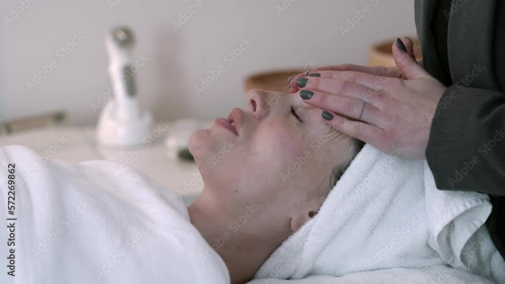 Person or woman receiving facial massage in a beauty salon Person or woman receiving facial massage in a beauty salon