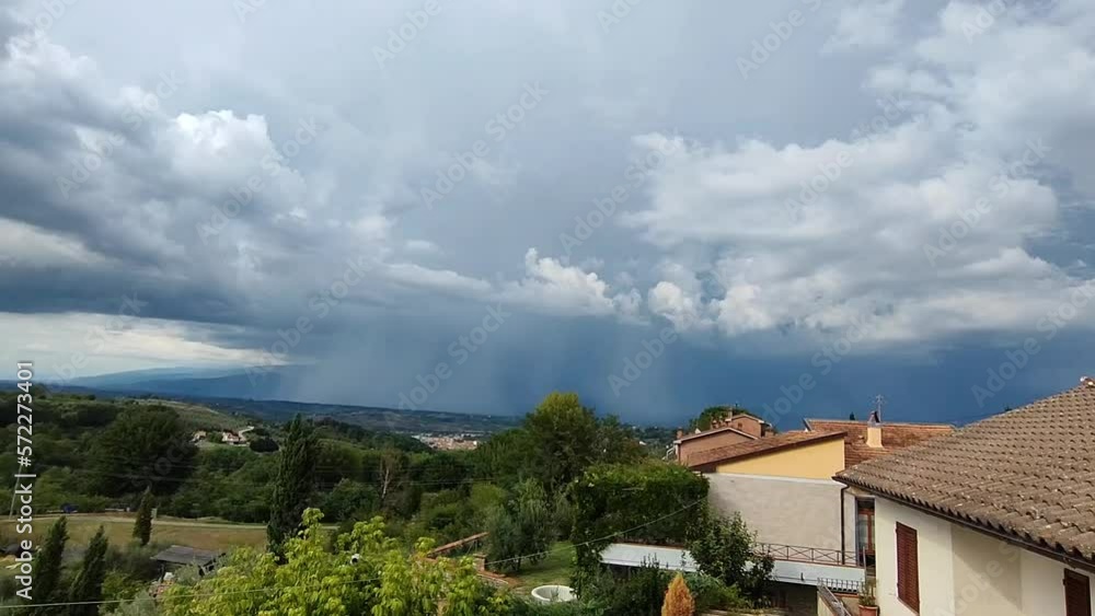 Thunderstorm with heavy rainfall and a cloud-to.ground lightning bolt over hills far away. Hand-held slow motion shot. Thunderstorm with heavy rainfall and a cloud-to.ground lightning bolt over hills far away. Hand-held slow motion shot.
