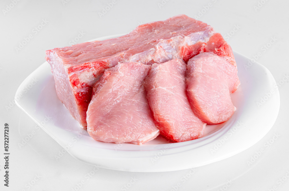Raw meat on white plate on white background Raw meat on white plate on white background