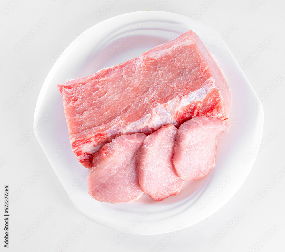 Raw meat on white plate on white background Raw meat on white plate on white background