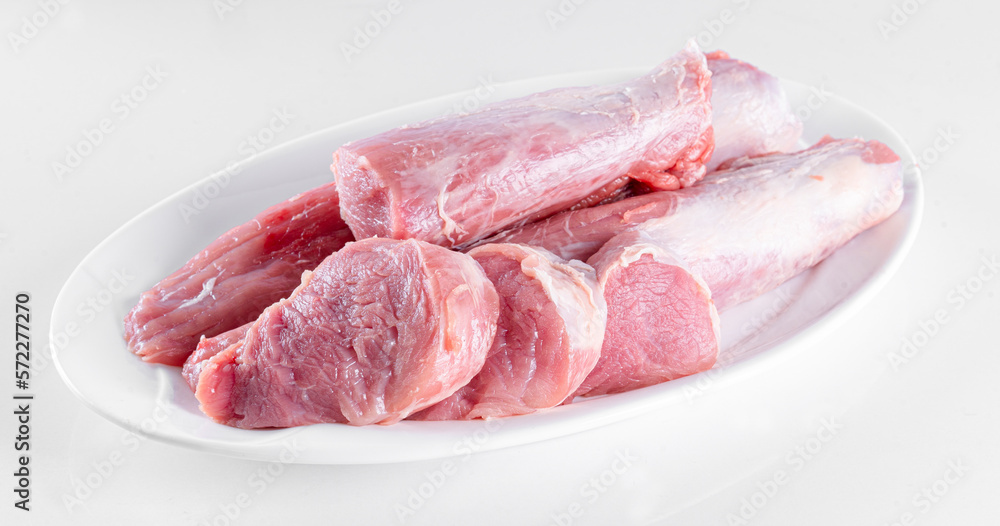 Raw meat on white plate on white background Raw meat on white plate on white background