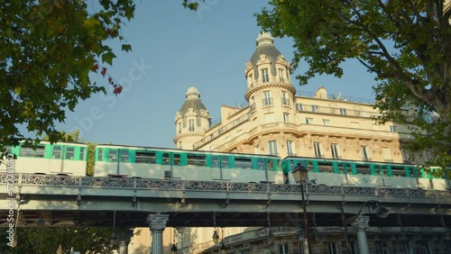 Metro train passing along the Parisian street in summer