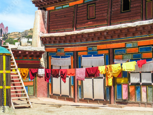 exterior of a Tibetan temple with hanging clothes © Brother's Art