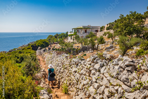 Gagliano del Capo, Salento. Some people follow the naturalistic path that from the Ciolo bridge leads to the spectacular Cipolliane caves, from which you can admire a beautiful panorama of the sea.