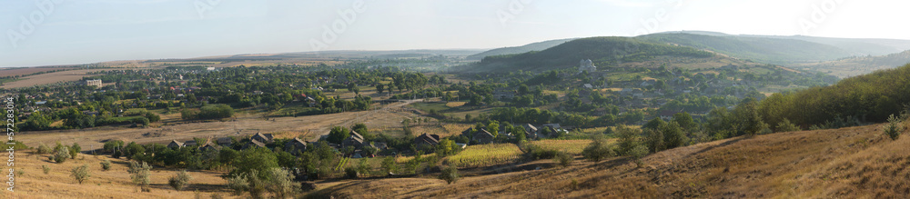 Beautiful rural landscape of a settlement on the hills, steppe rural life. Panorama.