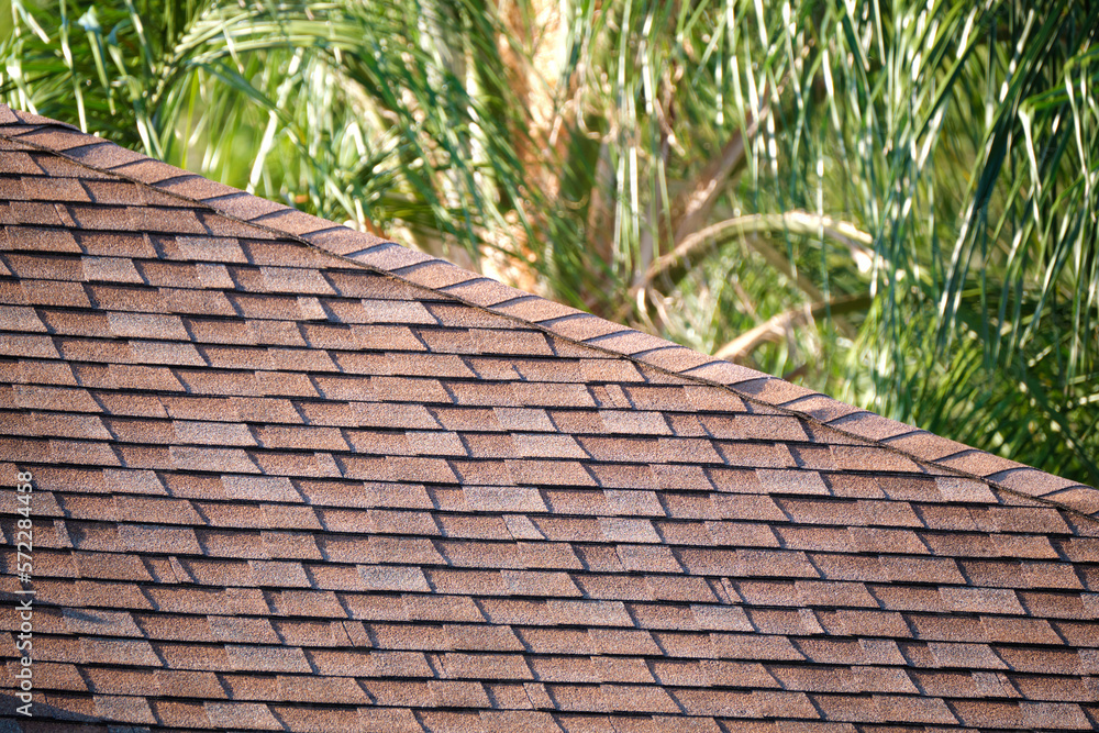 Closeup of house roof top covered with asphalt or bitumen shingles. Waterproofing of new building Closeup of house roof top covered with asphalt or bitumen shingles. Waterproofing of new building
