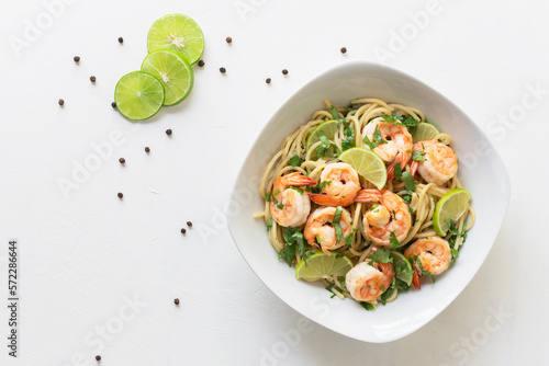 Shrimp pasta lemon coriander in white bowl on white background Italian food.