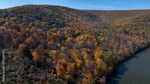 Mountains in Autumn with Fall colors in trees under blue sky in nature outdoors in American wilderness