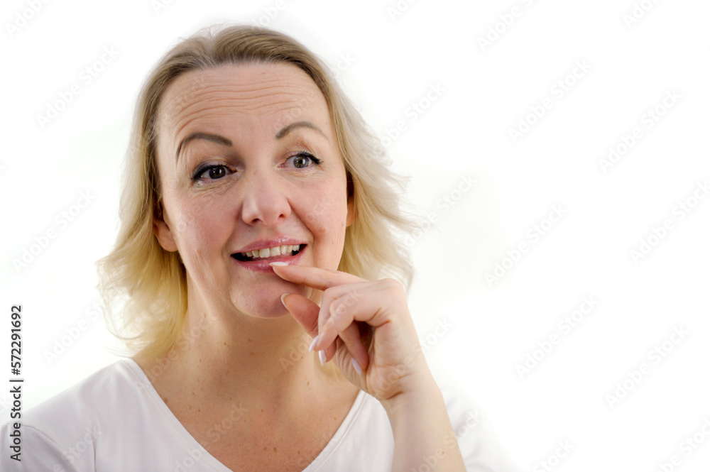 middle-aged woman dreams looks surprised holds hand near mouth advertising of dairy products white background blond hair presses green eyes raised eyebrows frowned little forehead positive emotions middle-aged woman dreams looks surprised holds hand near mouth advertising of dairy products white background blond hair presses green eyes raised eyebrows frowned little forehead positive emotions