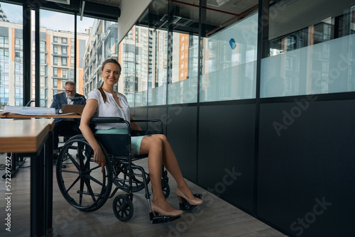 Woman with beautiful legs sits in a wheelchair