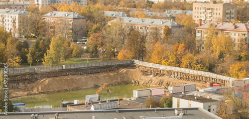 Construction site in a residential area of Moscow, dug in the ground pit filled with water, top view