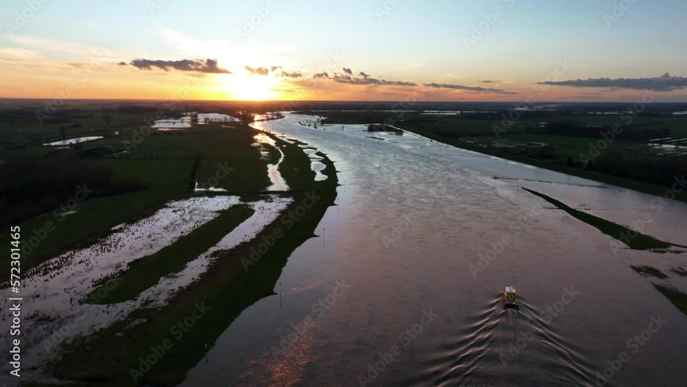 Ship sailing on the river IJssel in Overijssel aerial view during a winter sunset. Ship sailing on the river IJssel in Overijssel aerial view during a winter sunset.