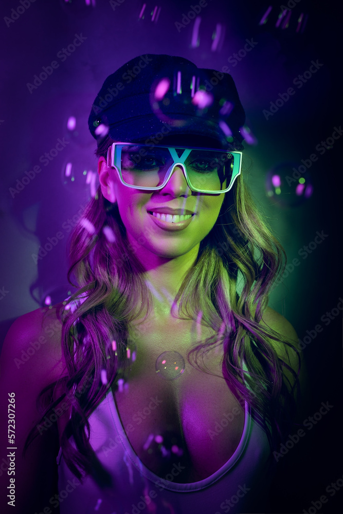 This photo features a woman with a big smile, wearing large sunglasses and surrounded by flying soap bubbles. She is wearing a white one-piece swimsuit, has curly hair, and a beret on her head, giving This photo features a woman with a big smile, wearing large sunglasses and surrounded by flying soap bubbles. She is wearing a white one-piece swimsuit, has curly hair, and a beret on her head, giving