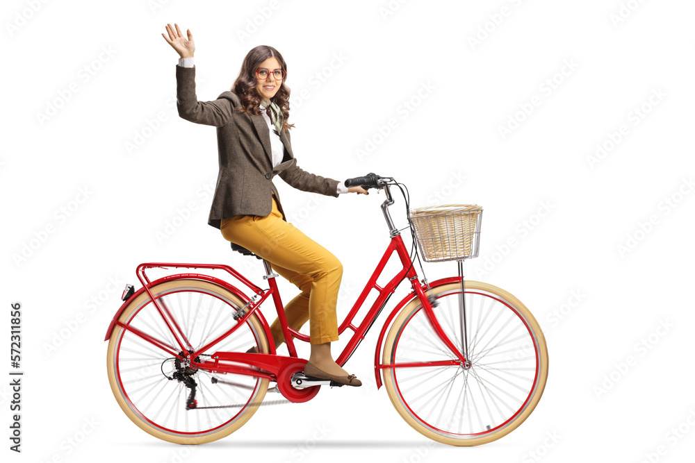 Young woman riding a bicycle to work and waving Young woman riding a bicycle to work and waving