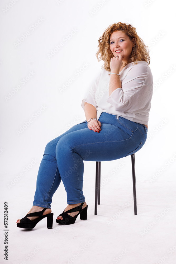Fototapeta premium Plus size fashion model, fat woman in denim clothes and white shirt on white background, overweight female body