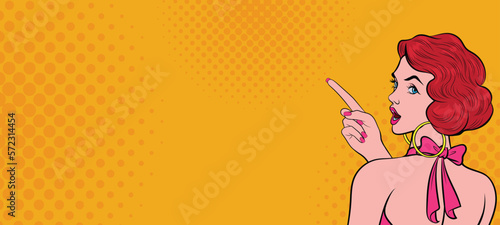 Shocked beautiful young woman pointing hand at something in retro pop art comic style. Color dots.