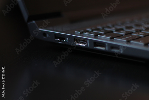 Detail view of a laptop. USB, HDMI and network sockets in laptop closeup shot.
