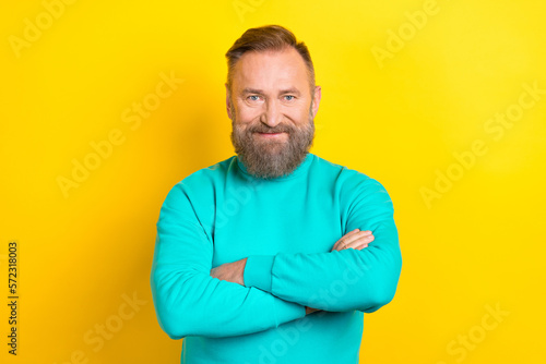 Photo of successful man wear stylish cyan clothes arm crossed finished work good mood isolated on yellow color background