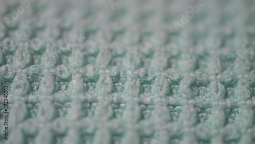 Cinematic panning macro photo of a blue microfiber cleaning cloth
