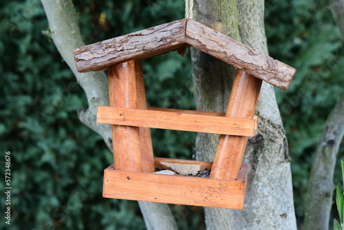 Small wooden house for feeding birds in winter
