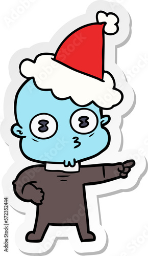 sticker cartoon of a weird bald spaceman wearing santa hat © lineartestpilot