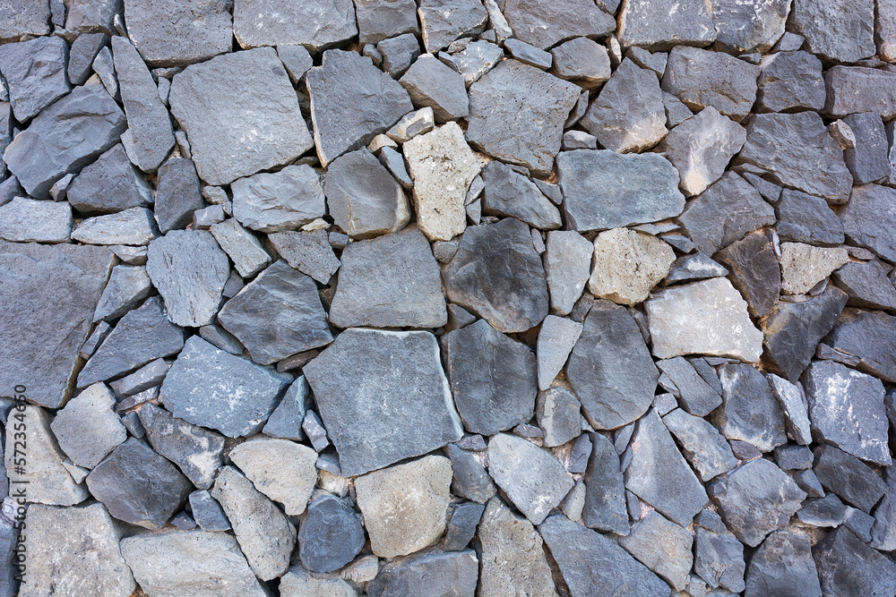 Stones of different shapes and sizes are built into the wall Stones of different shapes and sizes are built into the wall