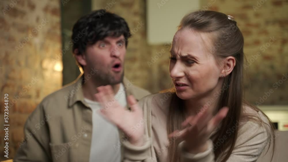 Family conflict, a quarrel of a young couple in the living room on the