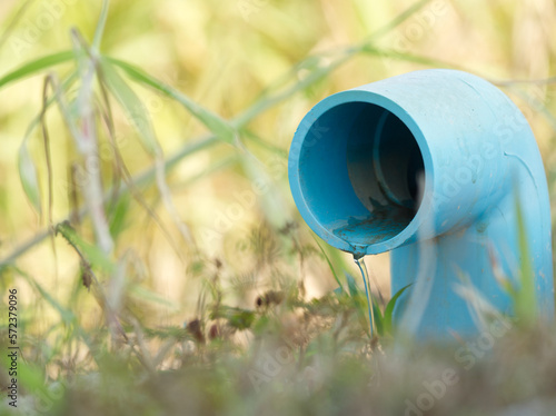 Water slowly flows from the pvc pipe into the farm
