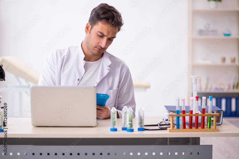 Young male chemist in drugs synthesis concept Young male chemist in drugs synthesis concept