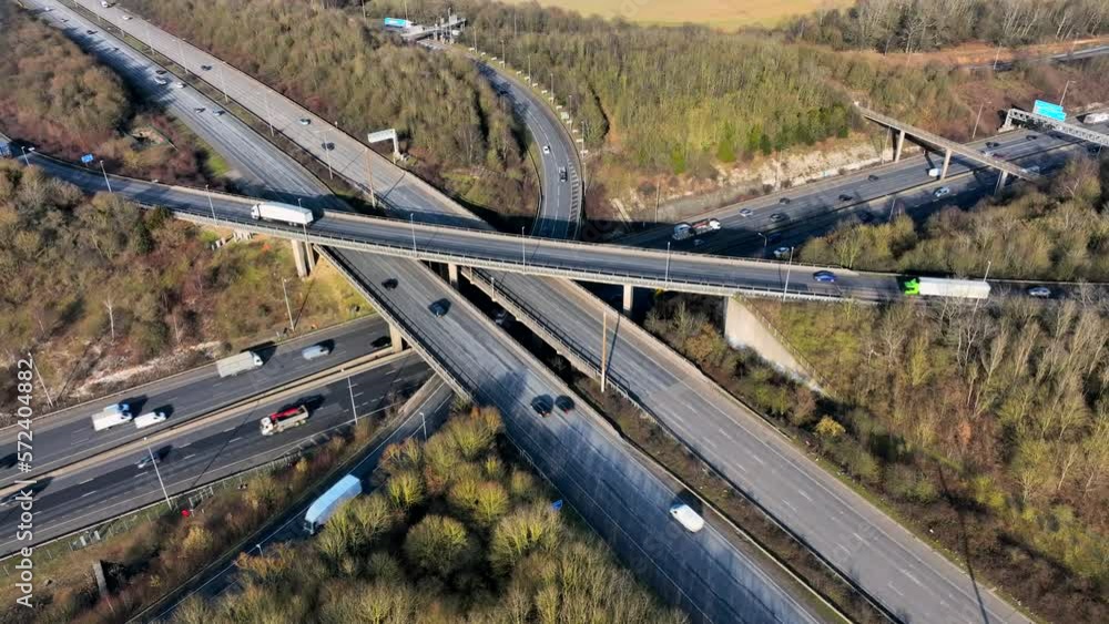 Vehicles Driving Along a Busy Motorway Interchange in the UK Aerial View Vehicles Driving Along a Busy Motorway Interchange in the UK Aerial View