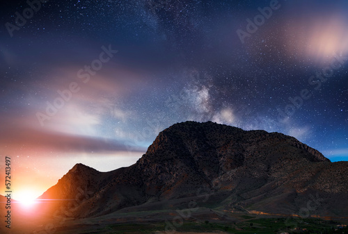 Fantasy night landscape. Beautiful snow covered mountains in the starry night with milky way galaxy. © Inga Av