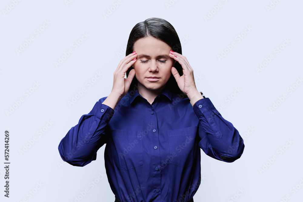 Young woman suffering from stress headache, over white background Young woman suffering from stress headache, over white background
