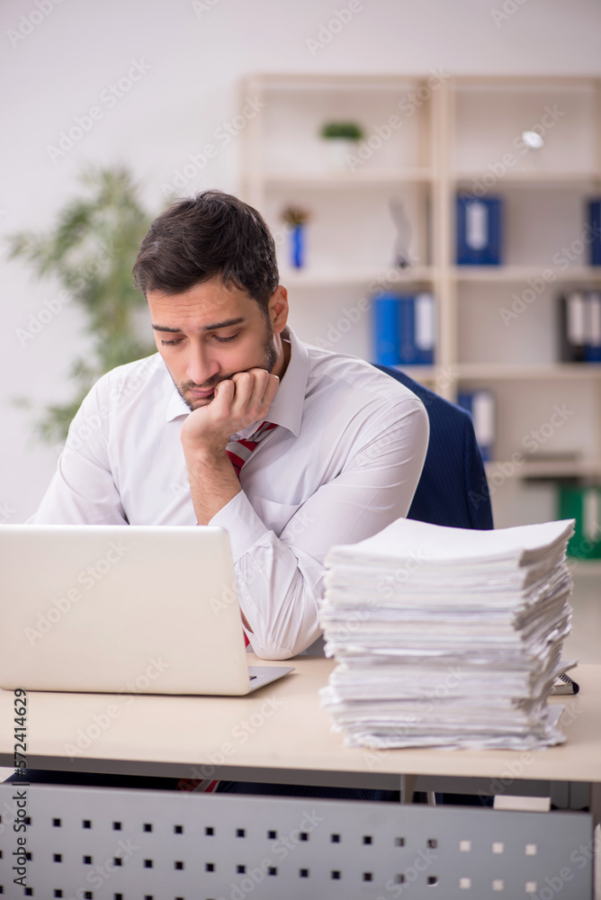 Young male employee working in the office Young male employee working in the office