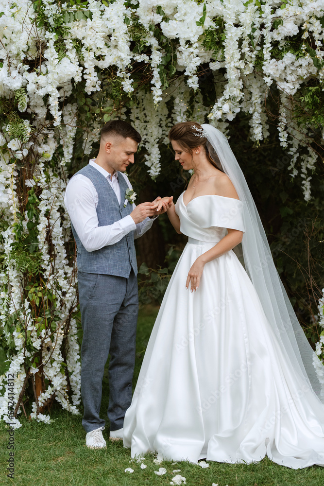 wedding ceremony of the newlyweds on the glade