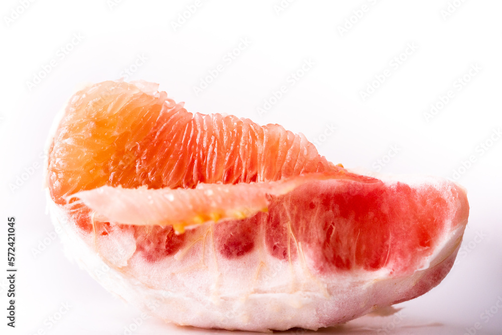 Pomelo on a white background.Advertising pomelo.Grapefruit.Pomelo pink. Fruit isolated.Cut pomelo on white background.Pomelo macro shot.Grapefruit macro shot.Juice drops on the fruit. fruit macro shot