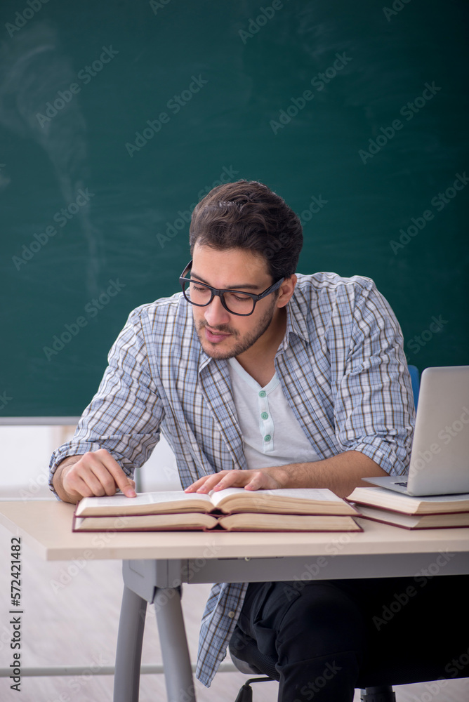 Young male student sitting in the classroom Young male student sitting in the classroom