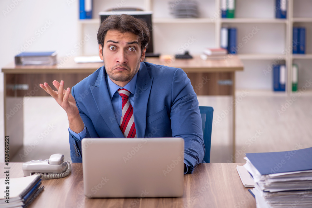 Young male employee working in the office Young male employee working in the office