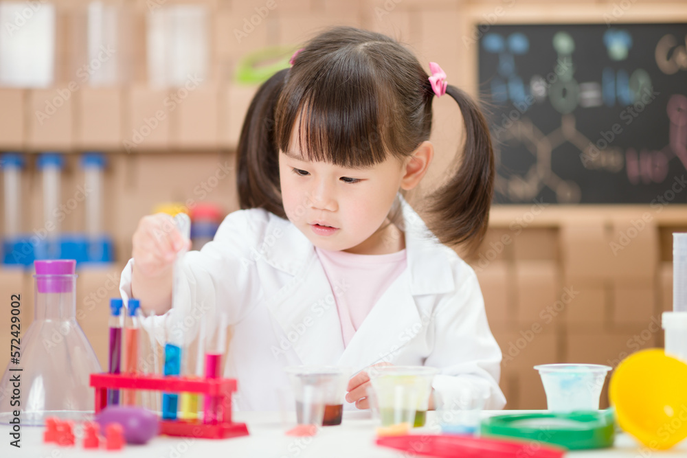 young girl plays  science experiment for home schooling