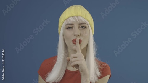 Lady is asking to be quiet. Silence gesture with finger. Slog2 ungraded LOG 10bit 422 ProRes raw chroma key footage photo