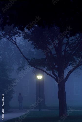 Student walks to class at Dartmouth College at dusk. New Hampshire photo