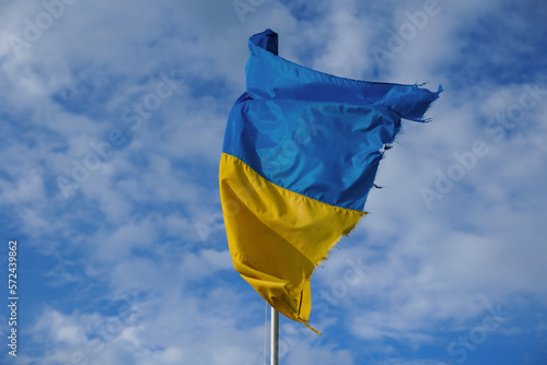 Ukrainian flag on the background of the blue sky. Unbreakable Ukraine