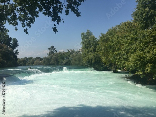 A photo from the manavgat waterfall, a touristic area in Turkey, a corner of paradise with trees photo